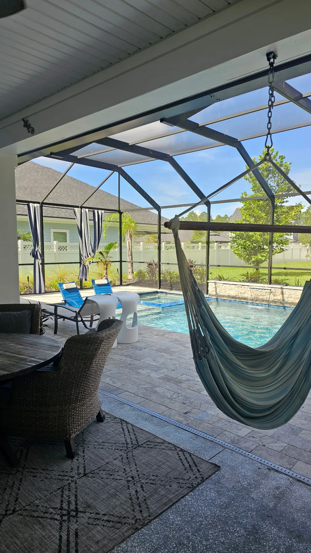 Daylight through the screen, hammock and loungers before the install