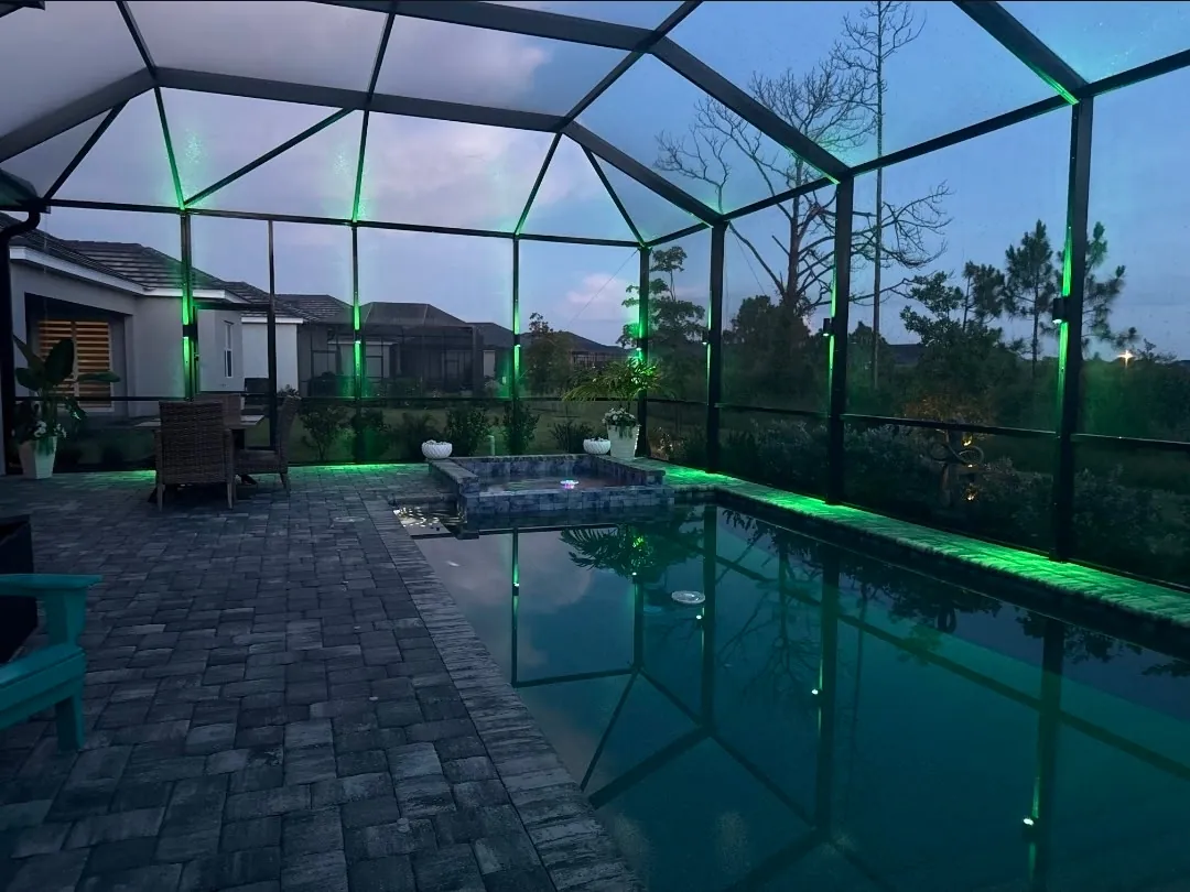The pool and lawn under green landscape light
