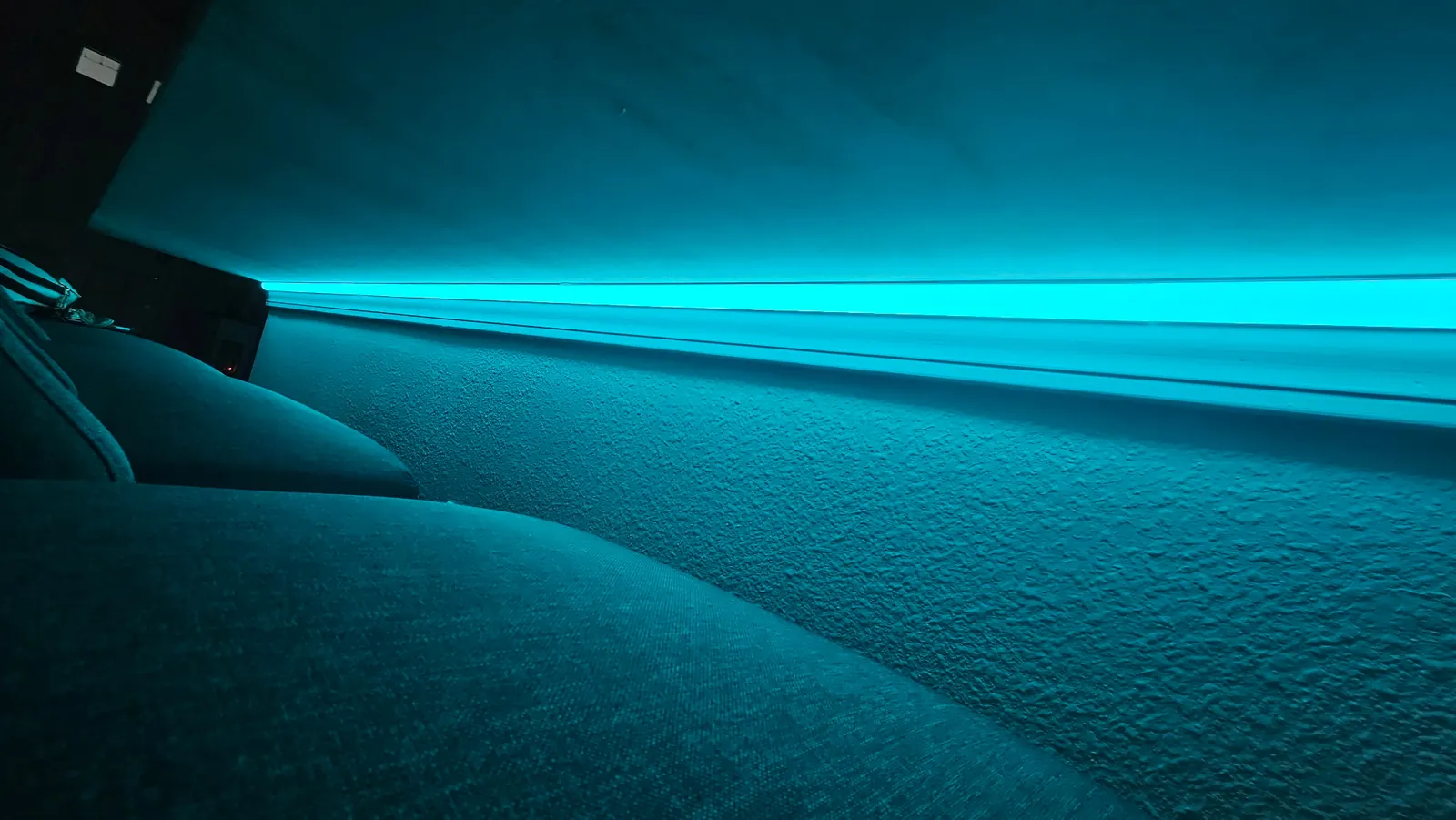 A stair tread strip, teal, up close