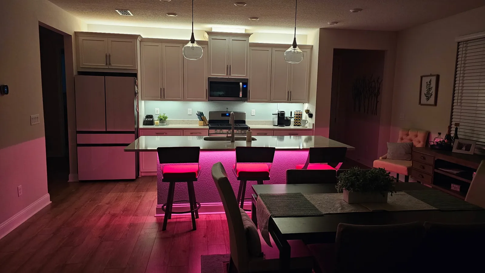 Under-cabinet light across the white kitchen