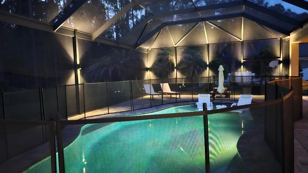 Downlights on every upright above a lit pool