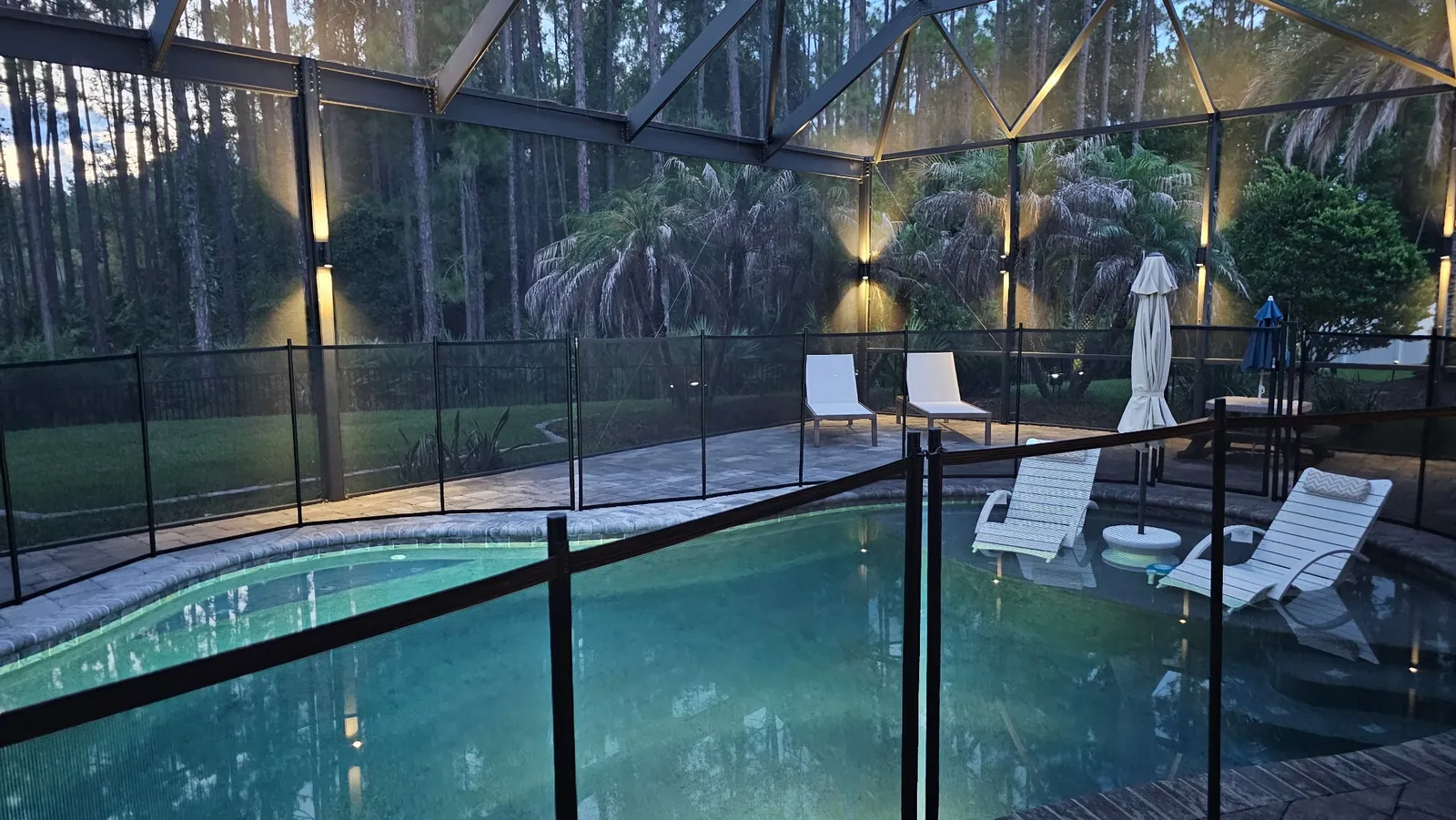 Pool and child fence inside the enclosure at dusk